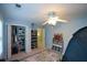 Blue bedroom with a tented bed, open closet, gray area rug, shelving and ceiling fan at 3295 Waters Ml, Alpharetta, GA 30022