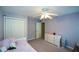 Bedroom with purple walls, closet, dresser, ceiling fan, and natural light from the window at 3295 Waters Ml, Alpharetta, GA 30022