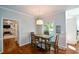 Cozy dining area with hardwood floors, a pendant light fixture, and views into the adjacent living room at 3295 Waters Ml, Alpharetta, GA 30022