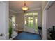 Bright foyer with hardwood floors and a view of the front yard through the glass paneled door at 3295 Waters Ml, Alpharetta, GA 30022
