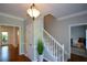 Foyer with hardwood floors, stairs, and elegant light fixture at 3295 Waters Ml, Alpharetta, GA 30022