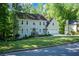 Traditional home with a manicured front lawn, blue entry door, and a two-car garage at 3295 Waters Ml, Alpharetta, GA 30022