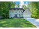 Charming home with a manicured lawn, gray stucco, blue front door, and a two-car garage at 3295 Waters Ml, Alpharetta, GA 30022