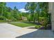 View from the side shows the well-manicured lawns and surrounding trees at 3295 Waters Ml, Alpharetta, GA 30022