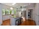 Modern kitchen featuring white cabinetry, stainless steel appliances, and a functional island with seating at 3295 Waters Ml, Alpharetta, GA 30022