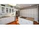 Modern kitchen with white cabinetry, stainless steel appliances, and center island with cooktop at 3295 Waters Ml, Alpharetta, GA 30022