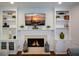 Living room featuring a fireplace with built-in shelving and white cabinetry at 3295 Waters Ml, Alpharetta, GA 30022