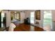Inviting living room featuring hardwood floors, barn door, and natural light from multiple windows at 3295 Waters Ml, Alpharetta, GA 30022