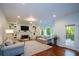 Bright living room with hardwood floors, recessed lighting, fireplace, and access to the outdoor deck at 3295 Waters Ml, Alpharetta, GA 30022
