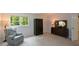 Cozy bedroom with recliner chair, natural light, and dark wood accents at 3295 Waters Ml, Alpharetta, GA 30022