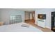 Spacious bedroom features wood flooring, television, and access to other rooms at 3295 Waters Ml, Alpharetta, GA 30022