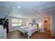 Comfortable bedroom with textured ceiling, wood-look floors, and a large window for natural light at 3295 Waters Ml, Alpharetta, GA 30022
