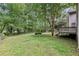 Spacious backyard with mature trees, a fenced perimeter, and a wooden deck at 4938 Cedar Lake Ter, Douglasville, GA 30135
