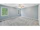 This bedroom features light blue walls, neutral carpeting, and bright windows at 4938 Cedar Lake Ter, Douglasville, GA 30135