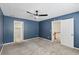 This is a bedroom with blue walls, carpet, and access to an ensuite bathroom at 4938 Cedar Lake Ter, Douglasville, GA 30135