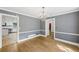 Open dining room with classic chandelier and hardwood floors leads into the kitchen at 4938 Cedar Lake Ter, Douglasville, GA 30135