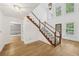 Sunlit foyer featuring hardwood floors, a staircase, and an open layout at 4938 Cedar Lake Ter, Douglasville, GA 30135