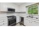 Functional kitchen with white cabinets, stainless steel appliances, and ample counter space at 4938 Cedar Lake Ter, Douglasville, GA 30135