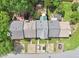 Aerial view showcases the property's roof, backyard, and driveway, in a neighborhood surrounded by mature trees and greenery at 1712 Grist Mill Dr, Marietta, GA 30062
