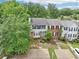 Aerial view of townhomes with manicured lawns and mature trees in a suburban neighborhood at 1712 Grist Mill Dr, Marietta, GA 30062