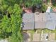 Aerial view of the property showcases its roof, backyard features, and driveway in a leafy neighborhood setting at 1712 Grist Mill Dr, Marietta, GA 30062