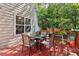 Cozy outdoor deck with a table and chairs, plants, and an umbrella that is great for enjoying the backyard at 1712 Grist Mill Dr, Marietta, GA 30062