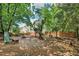 Large backyard with mature trees, wooden bench and slide, offers space for outdoor activities and relaxation at 1712 Grist Mill Dr, Marietta, GA 30062