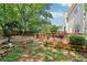 Backyard featuring a wooden deck, a fire pit, mature shade trees, and a wood privacy fence at 1712 Grist Mill Dr, Marietta, GA 30062
