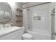 Bright bathroom with a modern vanity, bathtub and shower, white tiling, and stylish decorative shelves at 1712 Grist Mill Dr, Marietta, GA 30062