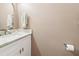 Powder room featuring a white sink and a marble countertop, perfect for guests at 1712 Grist Mill Dr, Marietta, GA 30062