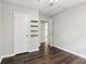Bedroom with ceiling fan, hardwood flooring, and an access door to the adjacent kitchen at 1712 Grist Mill Dr, Marietta, GA 30062