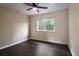Bedroom featuring a window with natural light and wood-look flooring throughout at 1712 Grist Mill Dr, Marietta, GA 30062