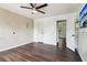 Bedroom featuring dark hardwood floors, white walls, and a textured accent wall at 1712 Grist Mill Dr, Marietta, GA 30062