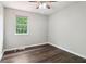 Bedroom with hardwood flooring, a ceiling fan, and a window providing ample natural light at 1712 Grist Mill Dr, Marietta, GA 30062