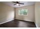 Bedroom with modern hardwood floors and a large window overlooking lush greenery at 1712 Grist Mill Dr, Marietta, GA 30062