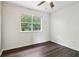 Bedroom featuring wood-look floors, white walls, and a single window for natural light at 1712 Grist Mill Dr, Marietta, GA 30062