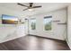 Bright bedroom featuring wood floors, ceiling fan, and two windows letting in natural light at 1712 Grist Mill Dr, Marietta, GA 30062