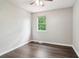 Bedroom features wood-look flooring, a bright window, and a ceiling fan with a light fixture at 1712 Grist Mill Dr, Marietta, GA 30062