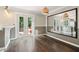 Sunlit dining area with hardwood floors, a large mirror, and access to the deck at 1712 Grist Mill Dr, Marietta, GA 30062