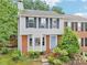 Charming two-story home featuring a brick facade and neutral siding, complemented by lush greenery and a well-manicured lawn at 1712 Grist Mill Dr, Marietta, GA 30062