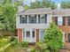Charming two-story home featuring a brick facade and neutral siding, complemented by lush greenery and a well-manicured lawn at 1712 Grist Mill Dr, Marietta, GA 30062