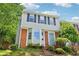 Close up of two-story townhouse featuring a bay window, brick accents, and a well-manicured front yard at 1712 Grist Mill Dr, Marietta, GA 30062