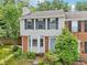 Two-story brick and siding townhome with black shutters and landscaping at 1712 Grist Mill Dr, Marietta, GA 30062