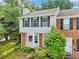 Two-story brick and siding townhome with black shutters and landscaping at 1712 Grist Mill Dr, Marietta, GA 30062