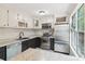 Modern kitchen with stainless steel appliances, white cabinets, and granite countertops at 1712 Grist Mill Dr, Marietta, GA 30062