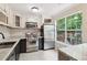 Bright kitchen with stainless steel appliances, granite countertops, and views of backyard at 1712 Grist Mill Dr, Marietta, GA 30062