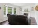 Bright living room with a large window and a black leather reclining sofa at 1712 Grist Mill Dr, Marietta, GA 30062