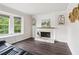 Cozy living room features a decorative fireplace, mantle, and large windows overlooking the landscape at 1712 Grist Mill Dr, Marietta, GA 30062