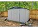 Backyard metal storage shed with double doors and wood fence at 1712 Grist Mill Dr, Marietta, GA 30062
