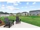 Spacious backyard featuring a patio with chairs and lush green lawn perfect for outdoor enjoyment at 2010 Moonlight Path, Covington, GA 30016